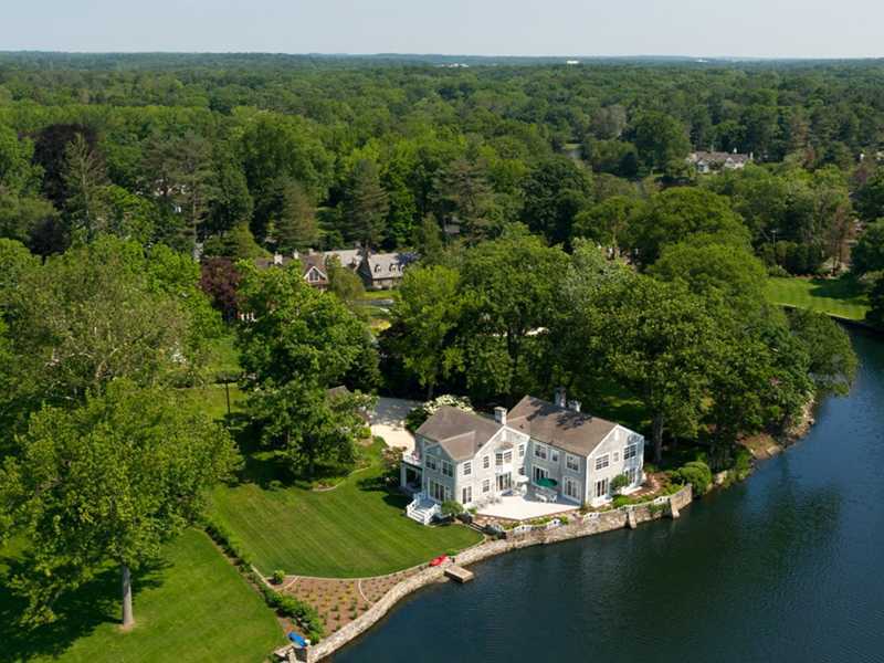 an aerial view of a house with a yard
