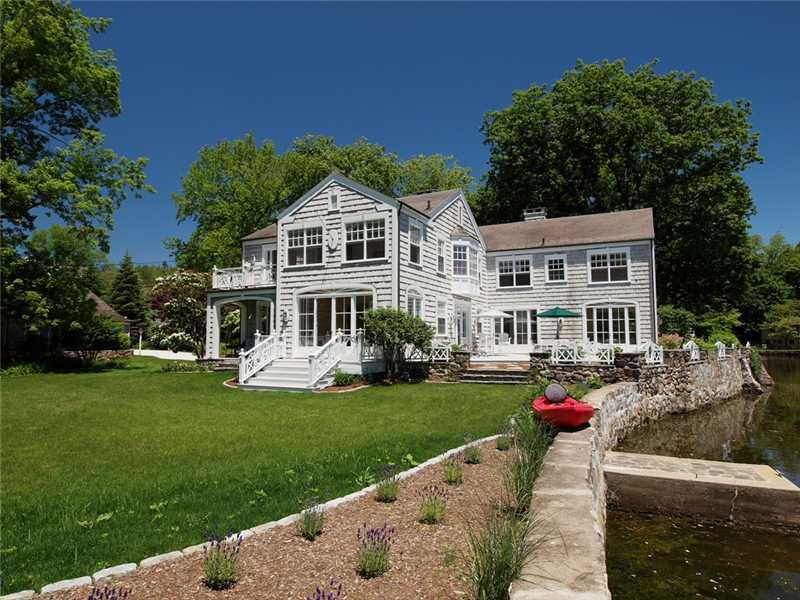 3 Coves End Road Darien, CT 06820 - Photo 21 of 22 a front view of a house with a garden and trees
