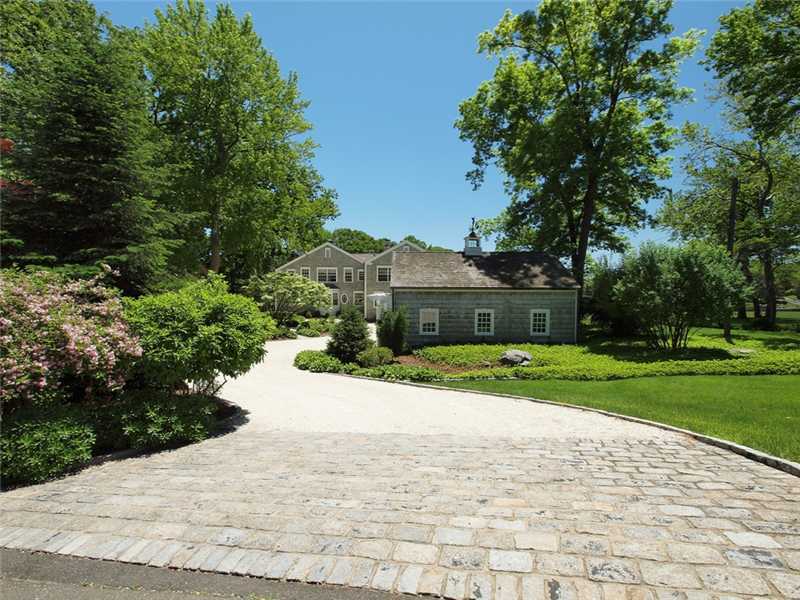 3 Coves End Road Darien, CT 06820 - Photo 3 of 22 a front view of a house with a yard and trees