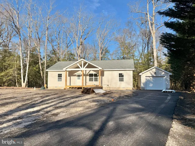 a view of a white house with a yard