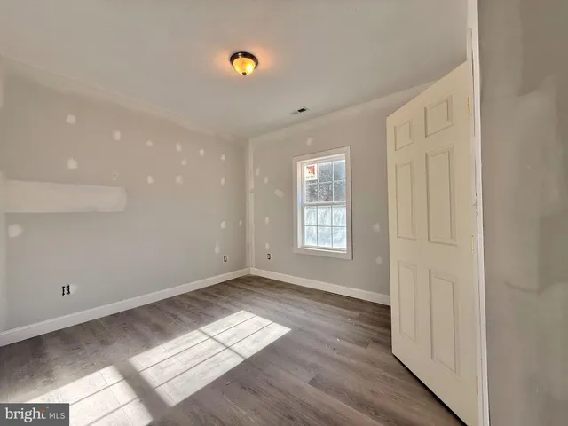 a view of wooden floor and windows in a room