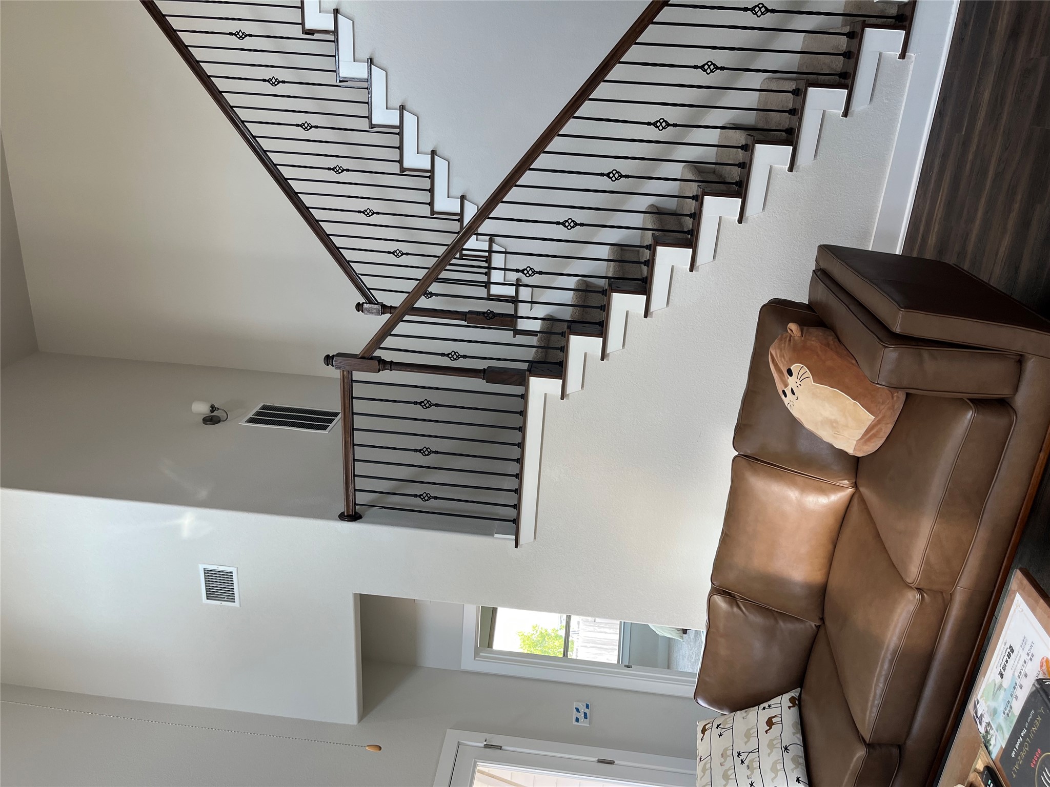 4420 Kings Cross Road Pflugerville, TX 78660 - Photo 11 of 13 A grand staircase with elegant wrought iron balusters and rich wood handrails defines this inviting living space.