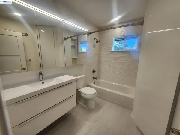 a bathroom with a double vanity sink toilet and shower