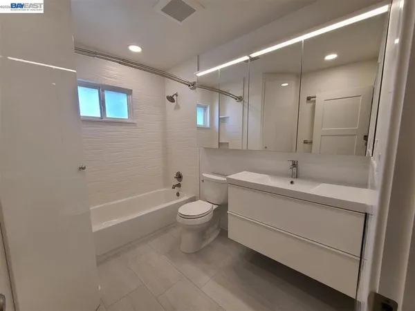 a bathroom with a toilet a sink and bathtub
