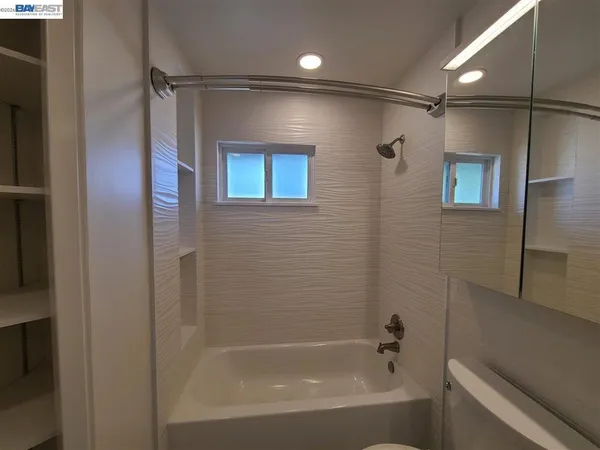 a bathroom with a shower and a bath tub
