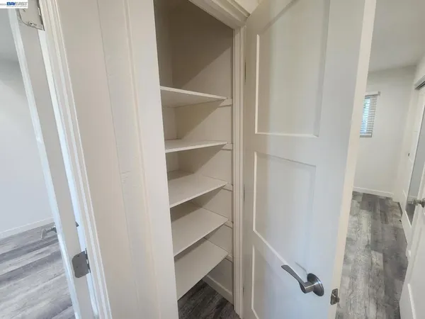 a view of walk in closet with empty racks