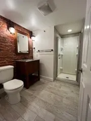 a bathroom with a toilet sink and mirror