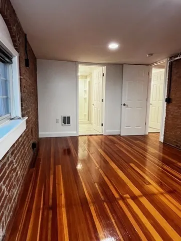 a view of a room with wooden floor and bench