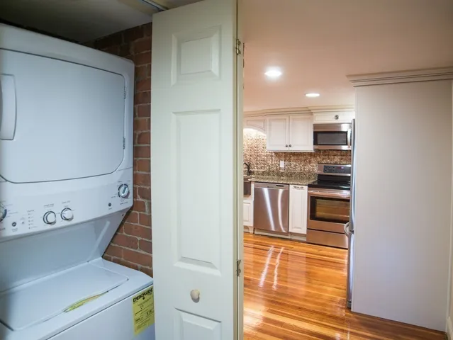 a view of open kitchen with wooden floor and electronic appliances