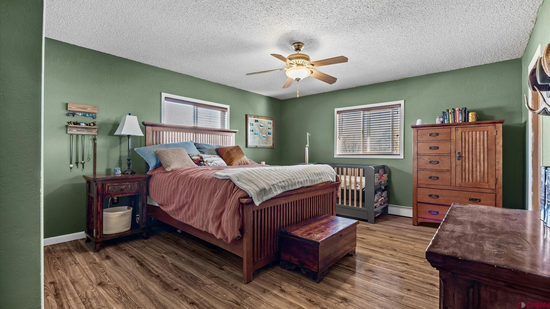 16205 6700th Road Montrose, CO 81401 - Photo 11 of 34 a bedroom with a bed and wooden floor