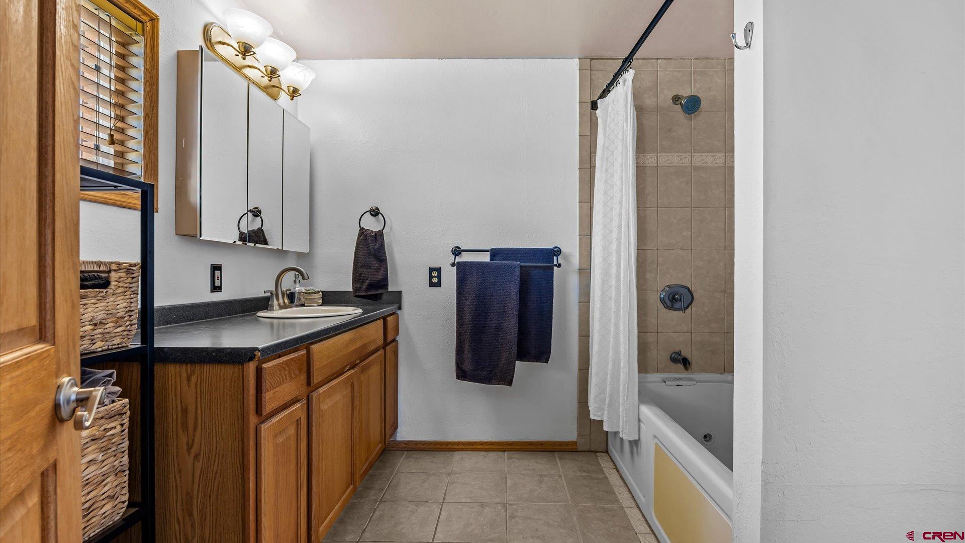 16205 6700th Road Montrose, CO 81401 - Photo 13 of 34 a bathroom with a granite countertop sink and a mirror