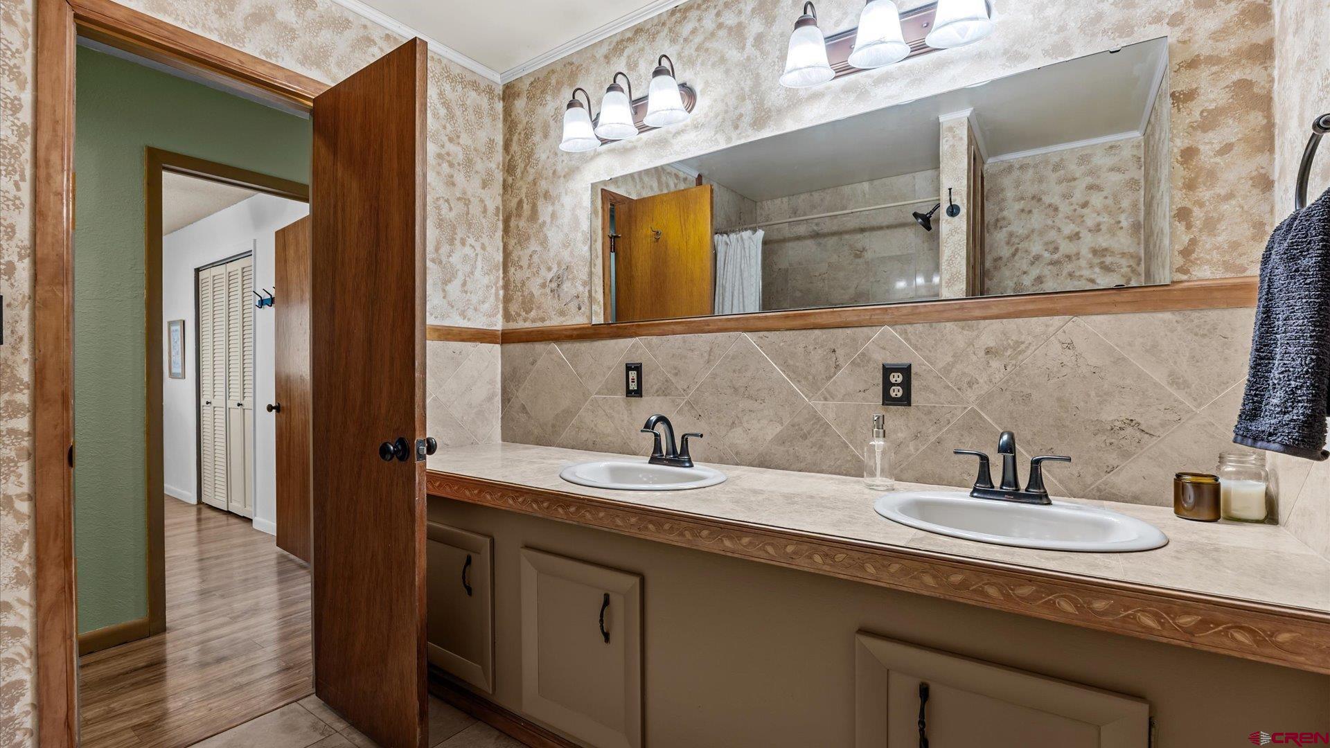 16205 6700th Road Montrose, CO 81401 - Photo 17 of 34 a bathroom with a double vanity sink and a mirror
