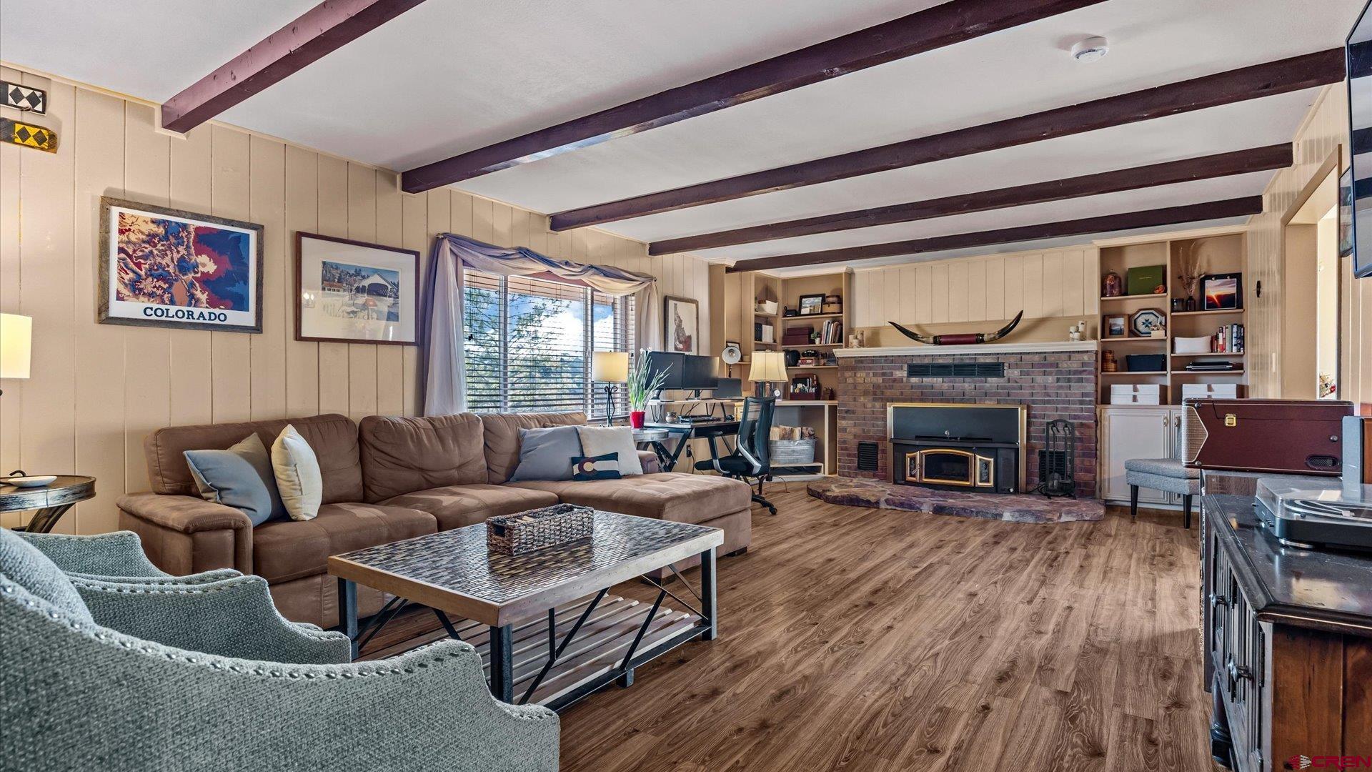 16205 6700th Road Montrose, CO 81401 - Photo 28 of 34 a living room with furniture a fireplace and a flat screen tv