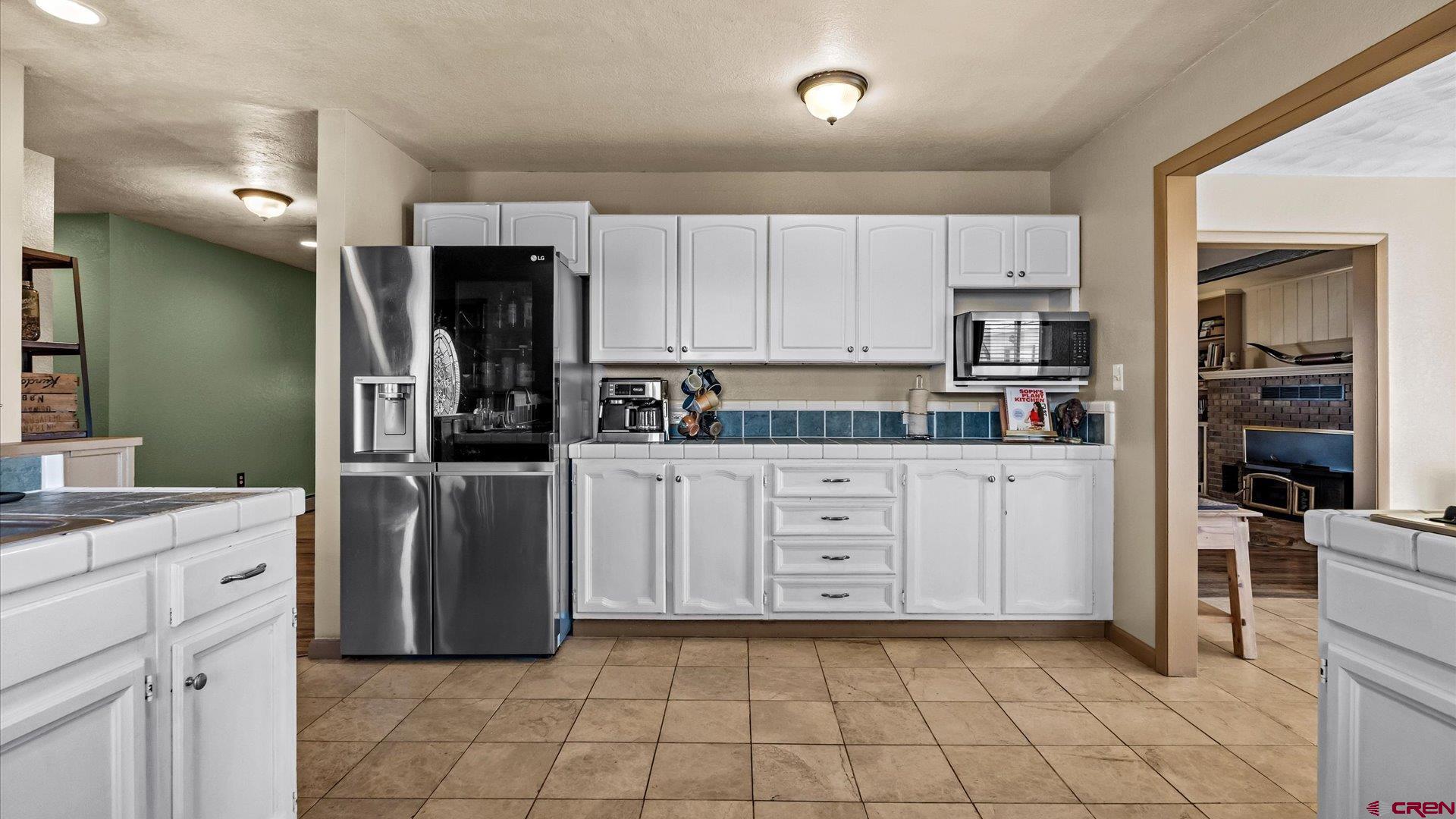 16205 6700th Road Montrose, CO 81401 - Photo 33 of 34 a kitchen with white cabinets and appliances