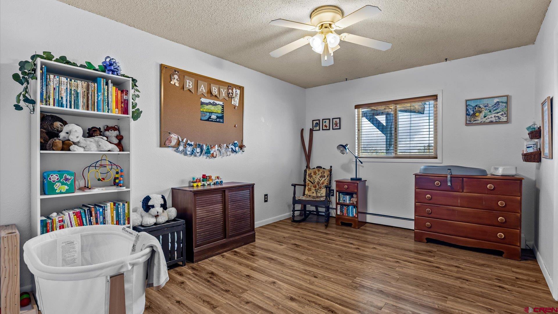 16205 6700th Road Montrose, CO 81401 - Photo 5 of 34 a living room with furniture and a bookshelf