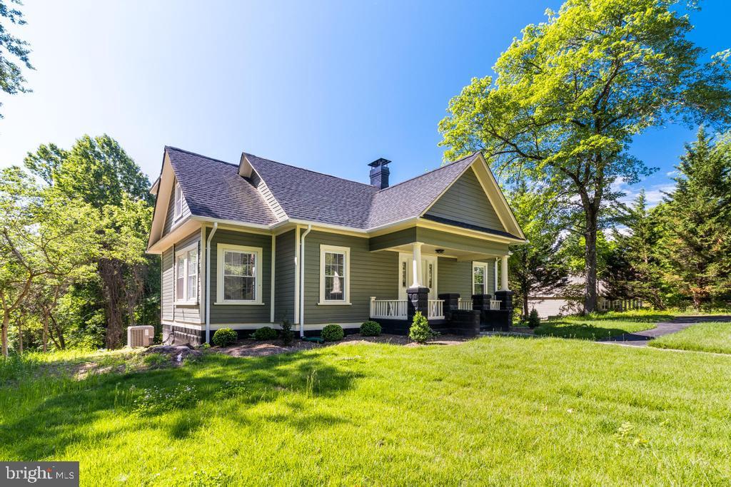 a front view of house with yard and green space