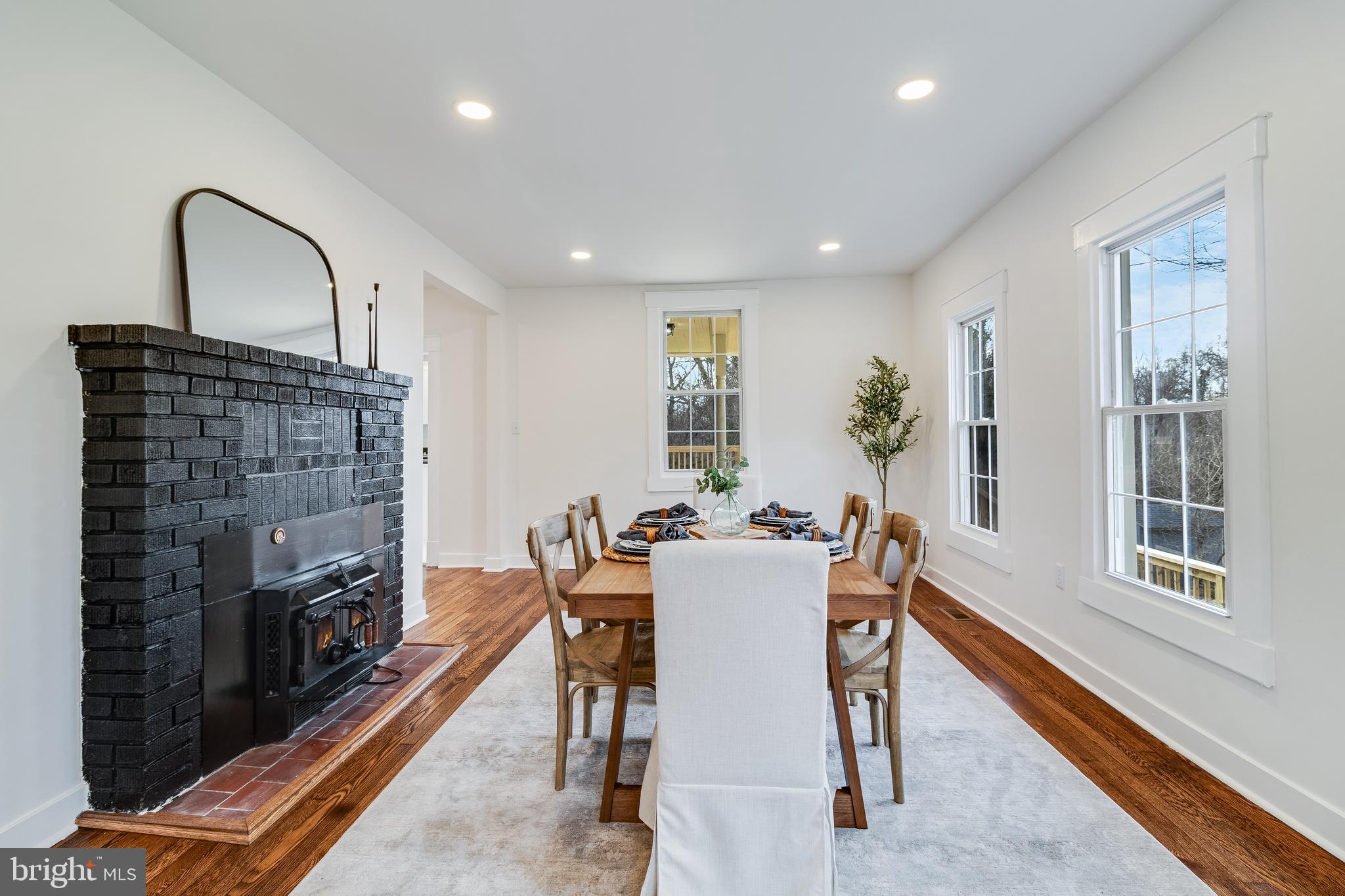 9316 Croom Road Upper Marlboro, MD 20772 - Photo 13 of 61 a dining room with furniture a fireplace and wooden floor