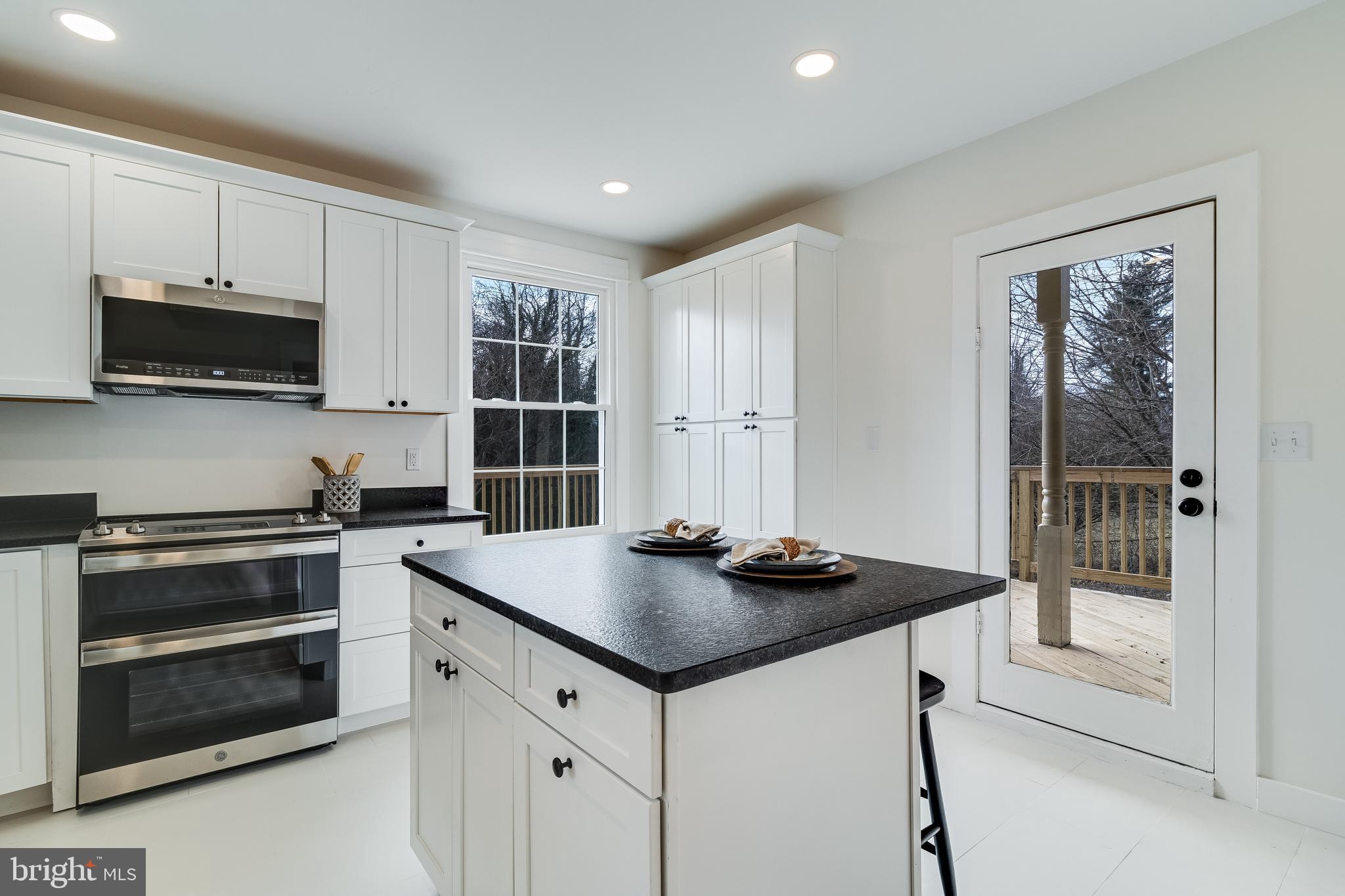 9316 Croom Road Upper Marlboro, MD 20772 - Photo 21 of 61 a kitchen that has a sink and a stove top oven