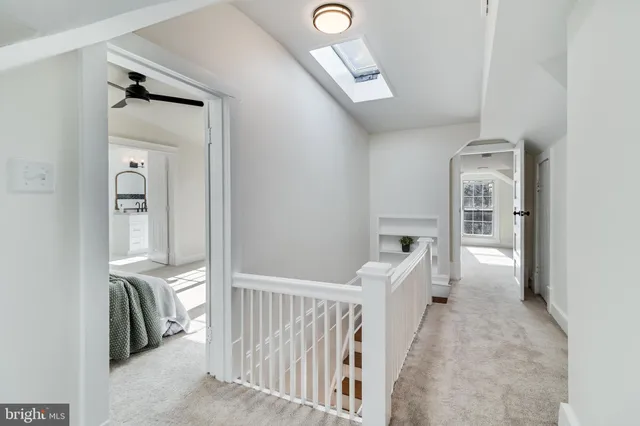 a view of a hallway with wooden floor and entryway