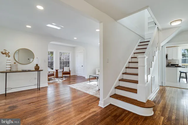 a view of a living room and entryway with wooden floor