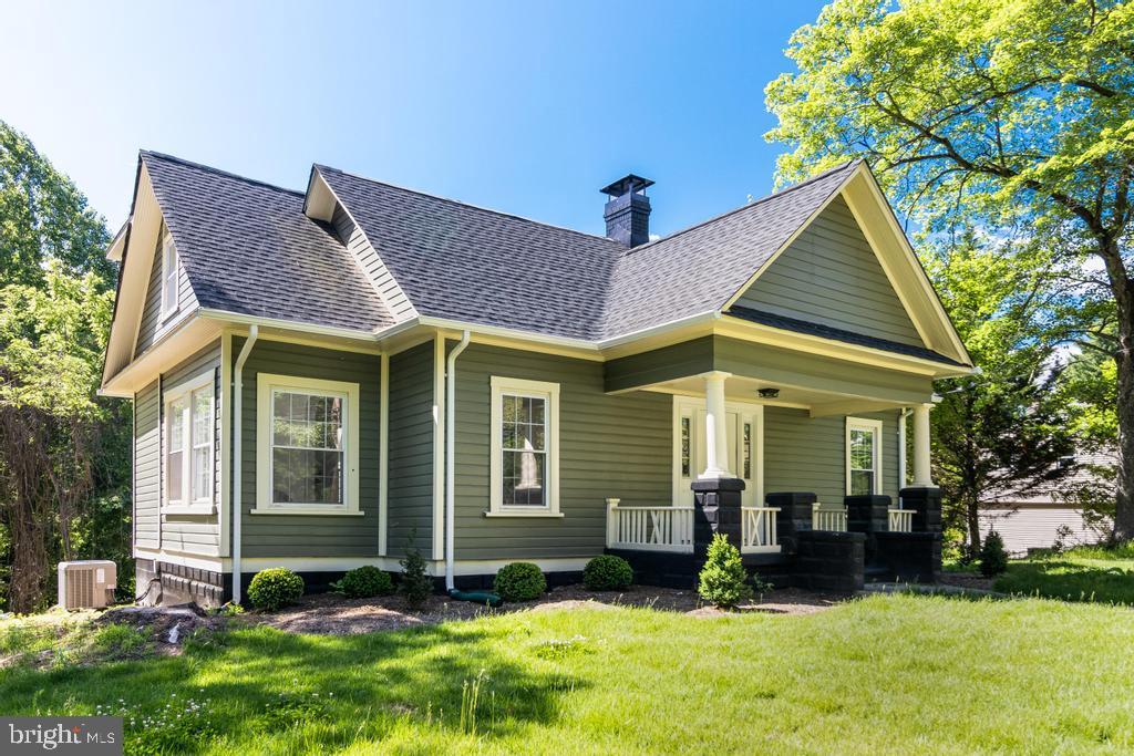 9316 Croom Road Upper Marlboro, MD 20772 - Photo 48 of 61 a view of a brick house with a yard plants and a large tree