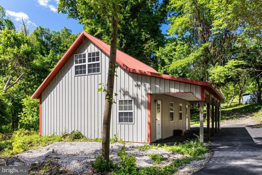 9316 Croom Road Upper Marlboro, MD 20772 - Photo 51 of 61 a view of a house with wooden fence next to a yard