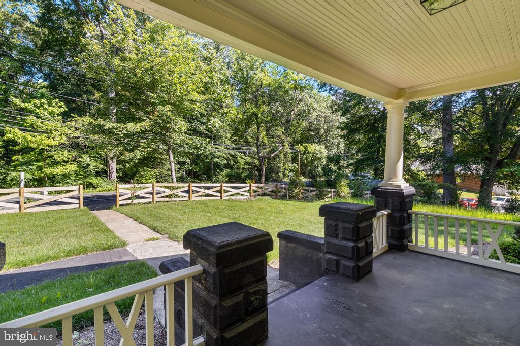 9316 Croom Road Upper Marlboro, MD 20772 - Photo 7 of 61 a view of a swimming pool and lounge chairs in back yard of the house