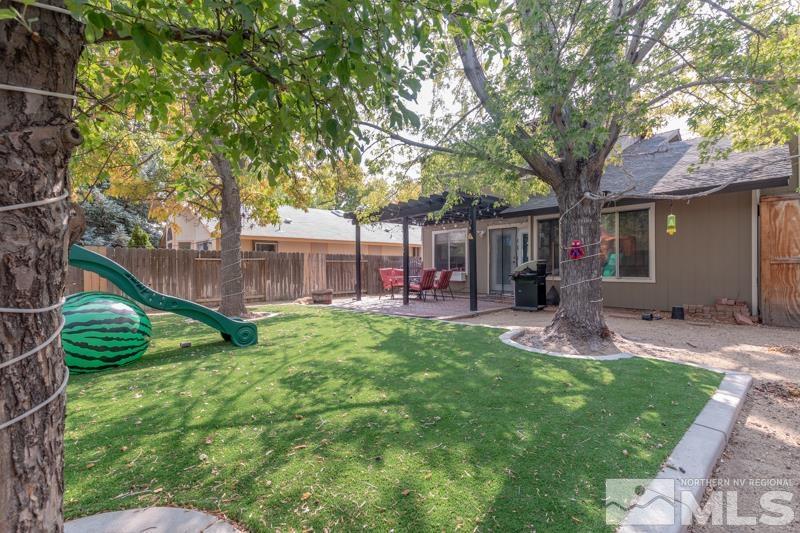 6023 Warm River Road Reno, NV 89523 - Photo 22 of 23 a view of a house with backyard and a tree