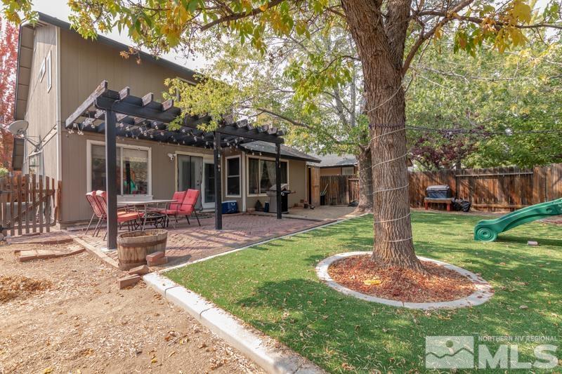 6023 Warm River Road Reno, NV 89523 - Photo 23 of 23 a view of a house with backyard and a tree