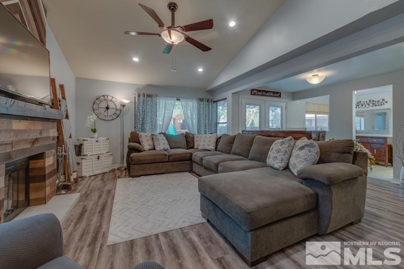 6023 Warm River Road Reno, NV 89523 - Photo 5 of 23 a living room with furniture a fireplace and a ceiling fan