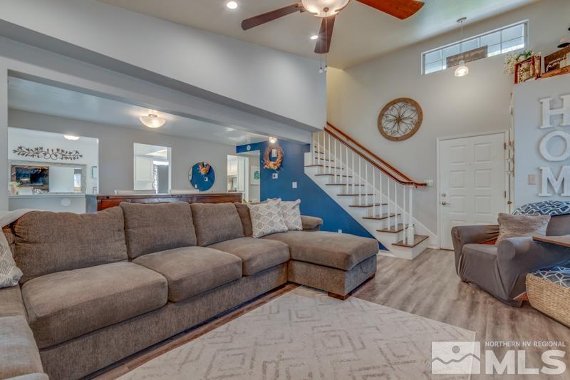 6023 Warm River Road Reno, NV 89523 - Photo 6 of 23 a living room with furniture a clock and a ceiling fan