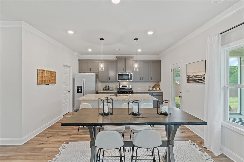 73 Cardinal Pond Lane Winder, GA 30680 - Photo 14 of 59 a dining room with kitchen island a table and chairs