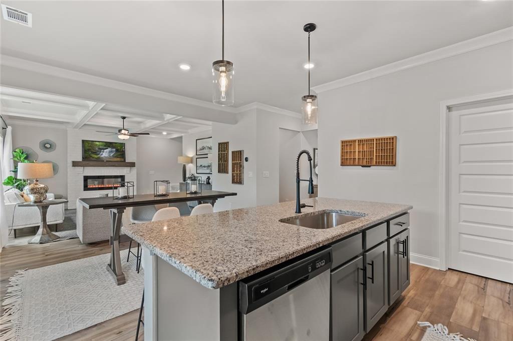 73 Cardinal Pond Lane Winder, GA 30680 - Photo 16 of 59 a kitchen with center island table and chairs in it