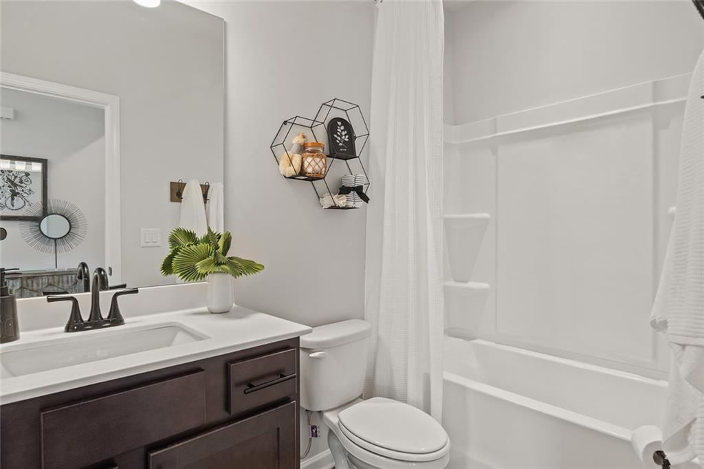 73 Cardinal Pond Lane Winder, GA 30680 - Photo 2 of 59 a bathroom with a sink a toilet and shower