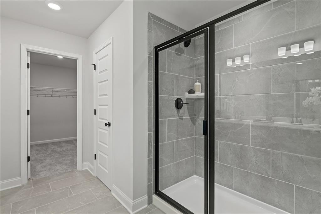 73 Cardinal Pond Lane Winder, GA 30680 - Photo 22 of 59 a bathroom with a glass shower door