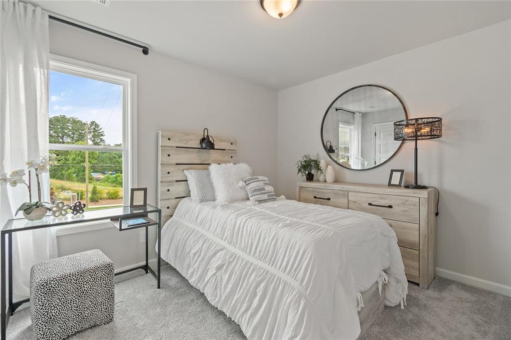 73 Cardinal Pond Lane Winder, GA 30680 - Photo 6 of 59 a bedroom with a bed a mirror and windows