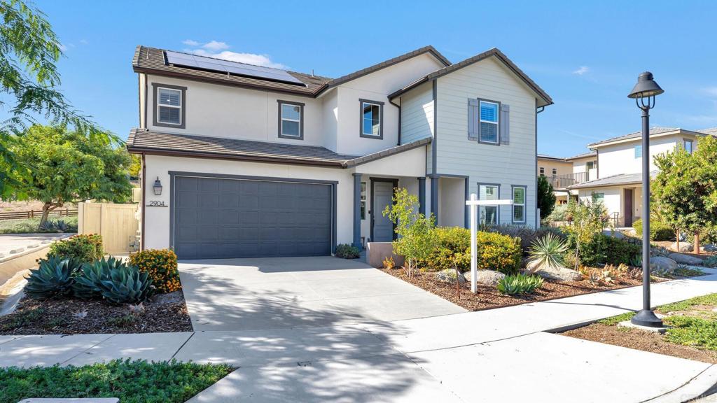 2904 Starry Night Drive Escondido, CA 92029 - Photo 1 of 54 a front view of a house with yard and garage