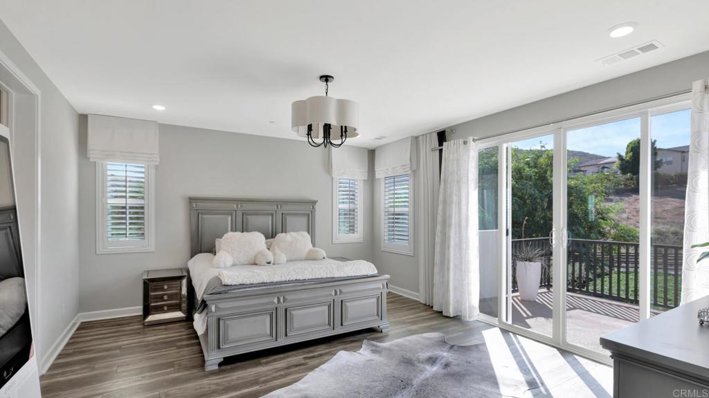 2904 Starry Night Drive Escondido, CA 92029 - Photo 11 of 54 a spacious bedroom with a bed and wooden floor