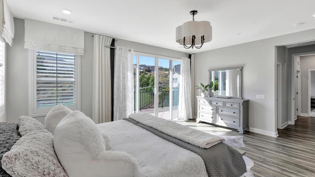 2904 Starry Night Drive Escondido, CA 92029 - Photo 12 of 54 a bedroom with a large bed and a chandelier