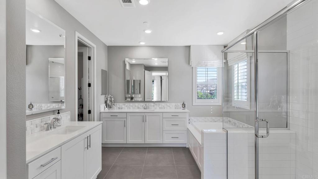 2904 Starry Night Drive Escondido, CA 92029 - Photo 17 of 54 a large bathroom with a double vanity sink a large mirror and a bathtub