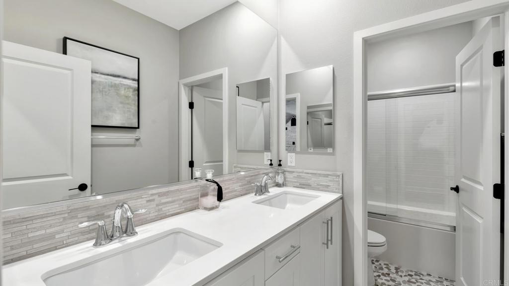 2904 Starry Night Drive Escondido, CA 92029 - Photo 23 of 54 a bathroom with a double vanity sink mirror and shower