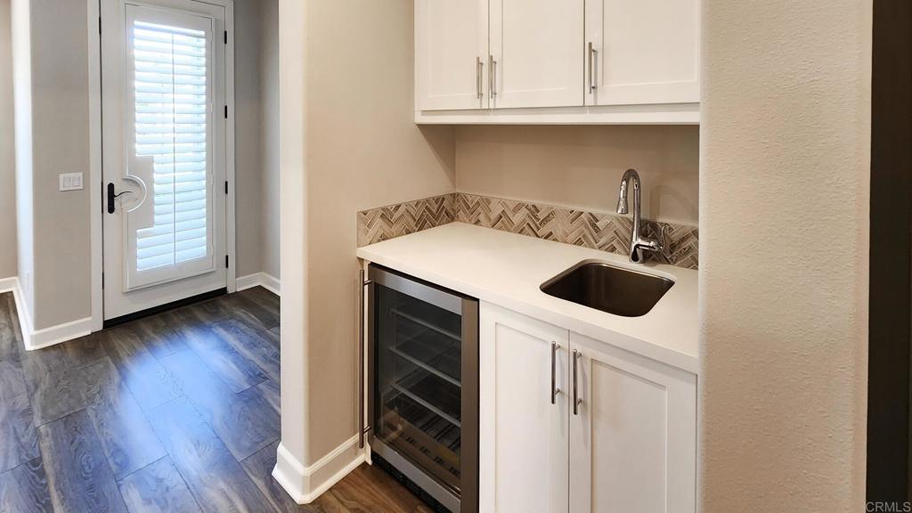 2904 Starry Night Drive Escondido, CA 92029 - Photo 25 of 54 a kitchen with a white cabinets and wooden floor