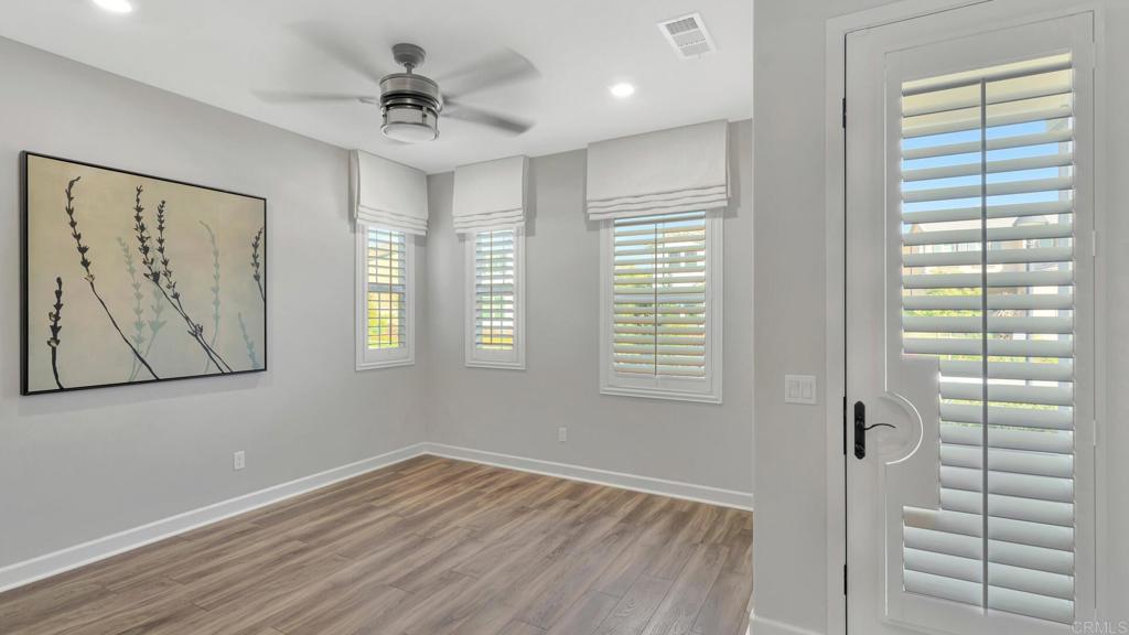 2904 Starry Night Drive Escondido, CA 92029 - Photo 27 of 54 a view of an empty room with a window and wooden floor