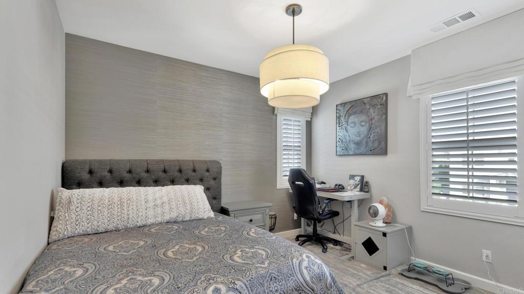 2904 Starry Night Drive Escondido, CA 92029 - Photo 31 of 54 a bedroom with a bed and a chandelier