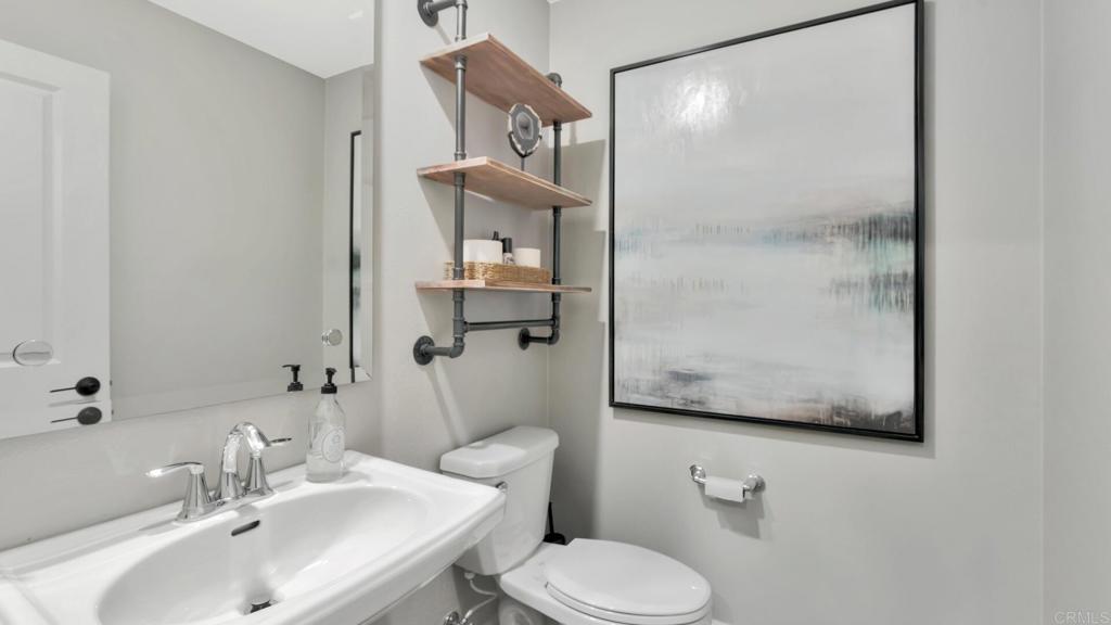 2904 Starry Night Drive Escondido, CA 92029 - Photo 32 of 54 a bathroom with a toilet sink and mirror