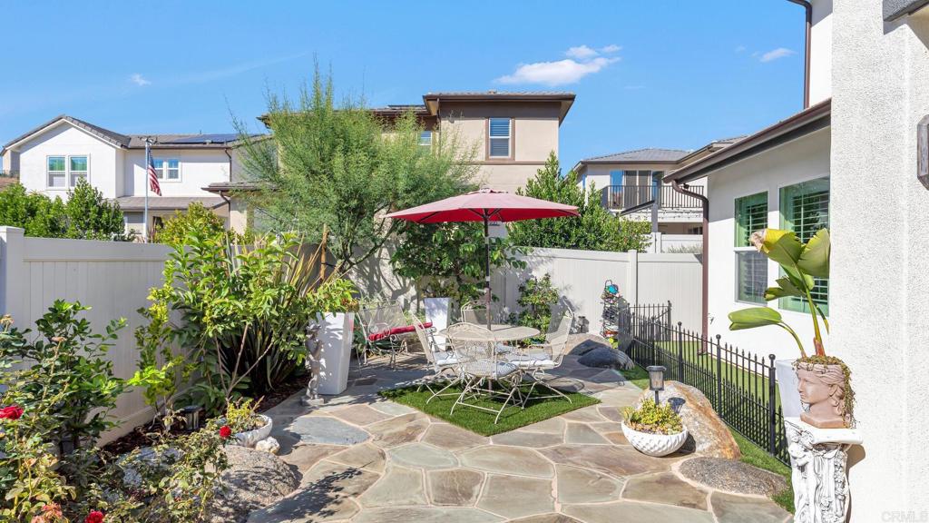 2904 Starry Night Drive Escondido, CA 92029 - Photo 37 of 54 a view of a patio with table and chairs under an umbrella