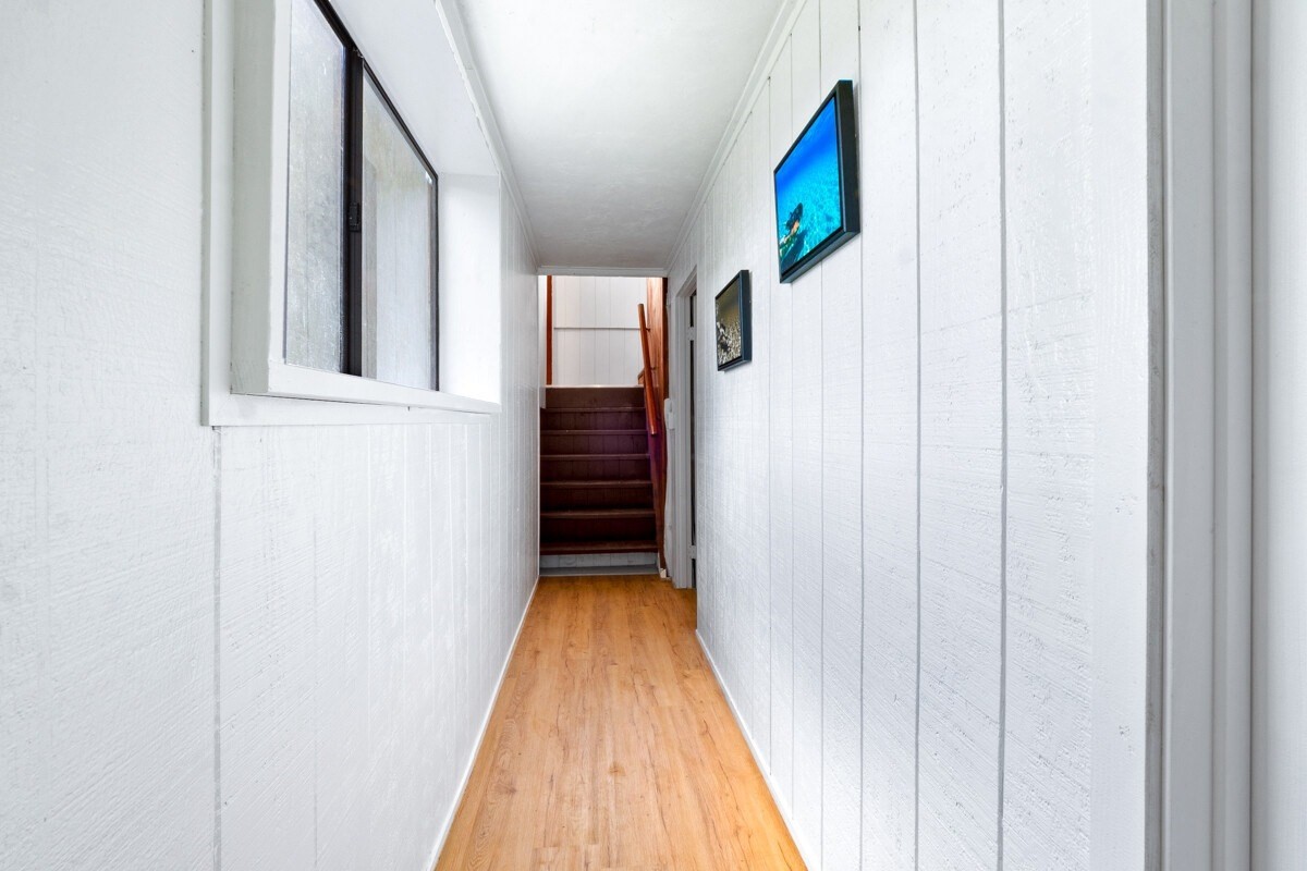 16-2006 Uhini Ana Road Mountain View, HI 96771 - Photo 25 of 25 a view of a hallway with wooden floor and staircase