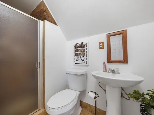 a bathroom with a sink toilet and mirror