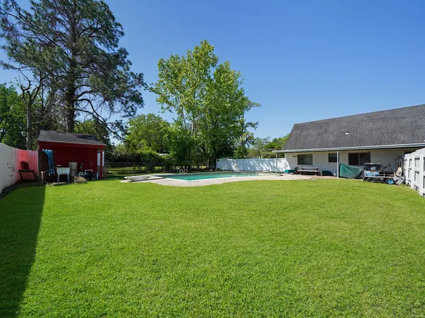 a view of house with swimming pool yard and outdoor seating