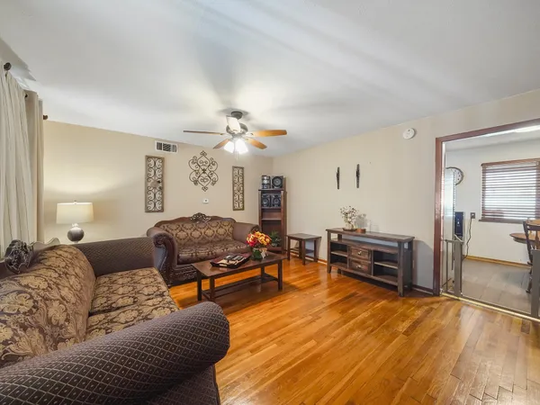 a living room with furniture and wooden floor